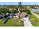 A captivating aerial view of a yellow home, showcasing the neighborhood and lush backyard at 2640 Geneva Rd, Venice, FL 34293