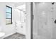 Bright bathroom featuring a sleek vanity with marble countertops and a modern glass enclosed shower at 2640 Geneva Rd, Venice, FL 34293