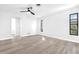 Bright bedroom with sleek flooring, modern ceiling fan, and views of the natural light from the windows at 2640 Geneva Rd, Venice, FL 34293