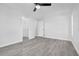 Bright bedroom featuring sleek flooring and doorways to the walk-in closet and additional rooms at 2640 Geneva Rd, Venice, FL 34293