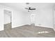 Bright bedroom featuring sleek flooring, a modern ceiling fan, and doorways to additional rooms at 2640 Geneva Rd, Venice, FL 34293