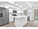 Modern kitchen features white cabinets, stainless steel appliances, and a center island at 2640 Geneva Rd, Venice, FL 34293