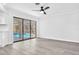 Bright living room with sleek flooring and expansive sliding glass doors offering a view of the pool at 2640 Geneva Rd, Venice, FL 34293