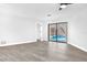 Bright living room with sleek floors, ceiling fan, and sliding glass doors to the pool at 2640 Geneva Rd, Venice, FL 34293
