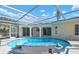 Large screened-in pool with tile accents, fountains, and access to outdoor areas at 2640 Geneva Rd, Venice, FL 34293