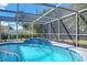 Relaxing screened-in pool with fountains and lush tropical landscaping at 2640 Geneva Rd, Venice, FL 34293