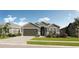 Charming single-story home with a two-car garage, neutral stucco exterior, and well-maintained landscaping at 286 Hillshire Pl, Spring Hill, FL 34609