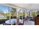 Bright dining area with large windows offering serene lake and garden views at 3008 Highlands Bridge Rd, Sarasota, FL 34235