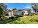 Charming home with a well-manicured lawn, lush landscaping, and a two-car garage at 3008 Highlands Bridge Rd, Sarasota, FL 34235