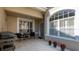 Inviting front porch with tile flooring, seating, and decorative plants at 3008 Highlands Bridge Rd, Sarasota, FL 34235