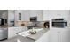 Modern kitchen with stainless steel appliances, granite countertops and sleek white cabinetry at 3008 Highlands Bridge Rd, Sarasota, FL 34235