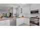 Bright, modern kitchen features stainless steel appliances, granite countertops, and white cabinetry at 3008 Highlands Bridge Rd, Sarasota, FL 34235