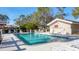 Community pool surrounded by lounge chairs and lush landscaping at 3008 Highlands Bridge Rd, Sarasota, FL 34235
