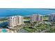 Gorgeous aerial view of waterfront condos with a tennis court, immaculate landscaping and beautiful ocean views at 3040 Grand Bay Blvd # 234, Longboat Key, FL 34228