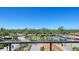 Expansive balcony with serene views of the tennis court, palm trees, and the neighborhood at 3040 Grand Bay Blvd # 234, Longboat Key, FL 34228