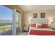 Bedroom showcasing water views, comfortable bedding and decor, and balcony access at 3040 Grand Bay Blvd # 234, Longboat Key, FL 34228