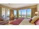 A bright bedroom featuring bay views and a comfortable bed with balcony access at 3040 Grand Bay Blvd # 234, Longboat Key, FL 34228