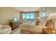 Bedroom with floral accents and a large window providing an amazing view at 3040 Grand Bay Blvd # 234, Longboat Key, FL 34228