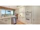 Bright kitchen featuring stainless steel appliances, white cabinetry, and a breakfast bar at 3040 Grand Bay Blvd # 234, Longboat Key, FL 34228