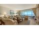 Comfortable living room with plush seating, area rug, and expansive windows showcasing stunning ocean views at 3040 Grand Bay Blvd # 234, Longboat Key, FL 34228