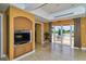 Inviting lounge with a TV and direct access to the outdoor pool area through sliding glass doors at 3040 Grand Bay Blvd # 234, Longboat Key, FL 34228