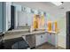 Bright kitchen featuring white cabinetry, stainless steel appliances, and a view into the adjacent living space at 3600 68Th N St, St Petersburg, FL 33710