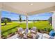 Relaxing covered patio with comfortable seating and picturesque views of the water at 3707 Ambersweet Crossing, Parrish, FL 34219
