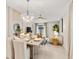 Inviting dining space featuring modern light fixture, neutral color palette, and seamless flow into the living area at 3707 Ambersweet Crossing, Parrish, FL 34219