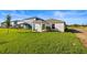 New construction single-Gathering home featuring a side porch and a spacious lawn at 3707 Ambersweet Crossing, Parrish, FL 34219