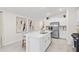 Contemporary kitchen showcasing stainless steel appliances, a center island with sink, and light, neutral finishes at 3707 Ambersweet Crossing, Parrish, FL 34219