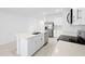 Clean white kitchen features stainless appliances, a large island, and ample storage space with great light at 3707 Ambersweet Crossing, Parrish, FL 34219