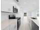 Well-equipped kitchen with quartz countertops, stainless steel appliances, and ample cabinet space at 3707 Ambersweet Crossing, Parrish, FL 34219