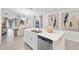 Open kitchen and dining area with stainless steel appliances, island sink, and modern light fixtures at 3707 Ambersweet Crossing, Parrish, FL 34219
