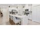 Modern kitchen featuring a large island, stainless steel appliances, and bright white cabinets at 3707 Ambersweet Crossing, Parrish, FL 34219