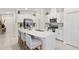 Modern kitchen featuring a large island, stainless steel appliances, and bright white cabinets at 3707 Ambersweet Crossing, Parrish, FL 34219