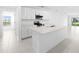 Modern kitchen with white cabinetry, stainless steel appliances, and a spacious center island at 3707 Ambersweet Crossing, Parrish, FL 34219