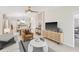 Bright living room with neutral tones featuring modern furnishings, TV, ceiling fan, and open floorplan at 3707 Ambersweet Crossing, Parrish, FL 34219