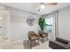 Well-lit living room with modern furnishings, a ceiling fan, and a view to the outdoor scenery at 3707 Ambersweet Crossing, Parrish, FL 34219