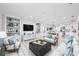 Open-concept living room with stylish built-in shelving, contemporary furnishings, and plenty of natural light at 3707 Ambersweet Crossing, Parrish, FL 34219