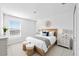 Bright bedroom with a large window, a wooden headboard, and minimalist decor at 3707 Ambersweet Crossing, Parrish, FL 34219