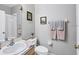 Bathroom featuring a single sink, toilet, and a towel rack with gray and pink towels next to an open shower at 3826 Virga Blvd, Sarasota, FL 34233