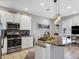 Stylish kitchen featuring granite countertops, stainless steel appliances, and a breakfast bar for casual dining at 3826 Virga Blvd, Sarasota, FL 34233