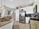 Modern kitchen boasts stainless steel appliances, granite counters and stylish backsplash at 3826 Virga Blvd, Sarasota, FL 34233