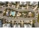 Overhead shot of a community pool and recreational areas surrounded by neatly parked cars and palm trees at 396 Aruba Cir # 302, Bradenton, FL 34209