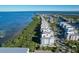 Aerial view showcases waterfront property with lush greenery and tranquil waters at 396 Aruba Cir # 302, Bradenton, FL 34209