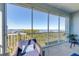 Relaxing screened balcony with seating and scenic views of the water and greenery at 396 Aruba Cir # 302, Bradenton, FL 34209
