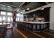 Upscale bar area featuring modern lighting, TVs, a stone backsplash, and ample seating at 396 Aruba Cir # 302, Bradenton, FL 34209