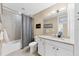 Well-lit bathroom with a shower/tub combination, granite countertops, and white cabinetry at 396 Aruba Cir # 302, Bradenton, FL 34209