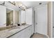 Bathroom featuring double sinks, granite countertops, white cabinets and a door to the toilet at 396 Aruba Cir # 302, Bradenton, FL 34209