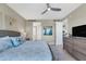 Bedroom featuring coastal decor, wicker bed, ensuite bath and television at 396 Aruba Cir # 302, Bradenton, FL 34209